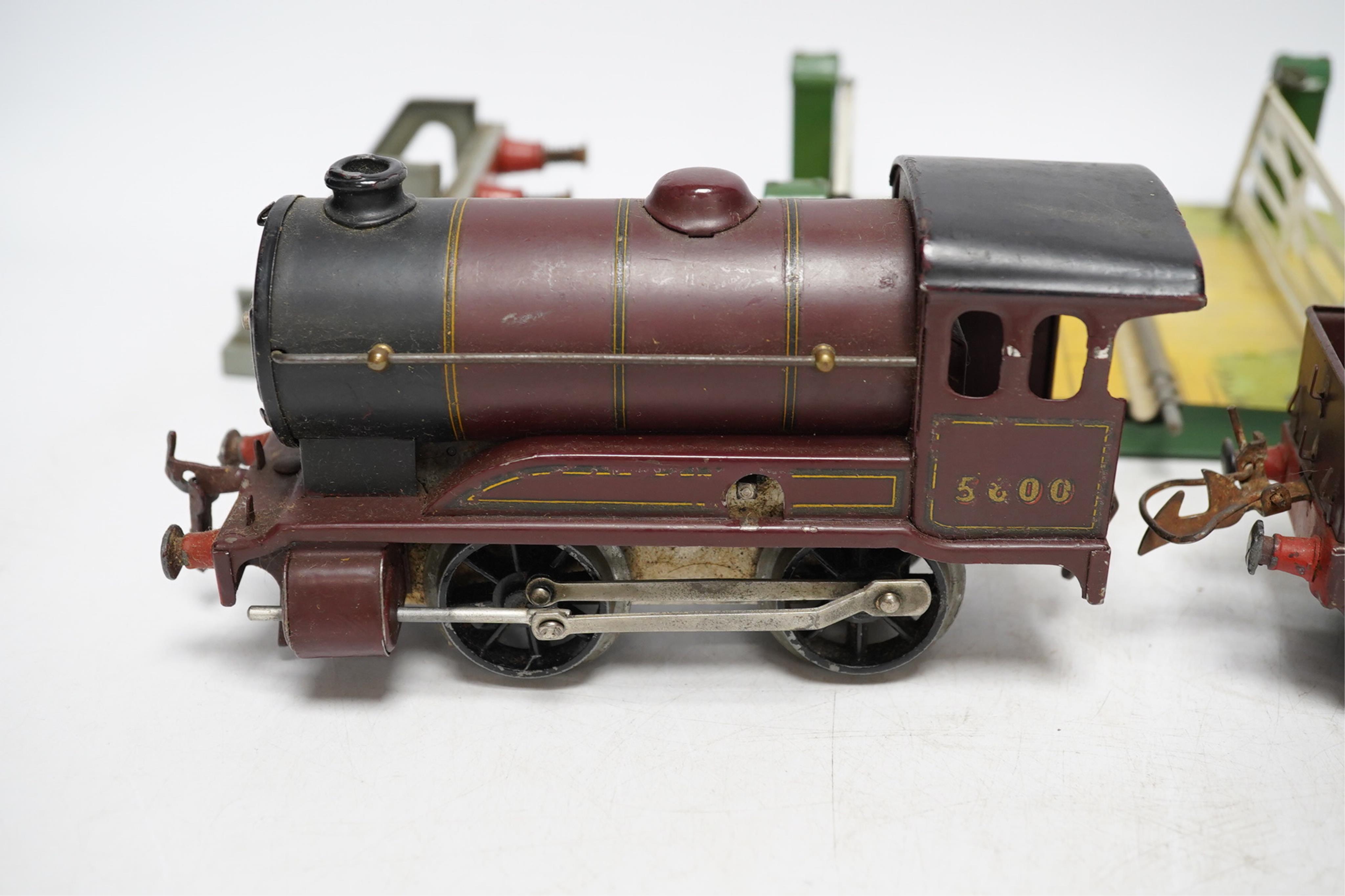 A Hornby 0 gauge clockwork No.501 0-4-0 tender locomotive, a No.1 Level Crossing, buffers and signal. Condition - poor to good, loco in the remains of its box